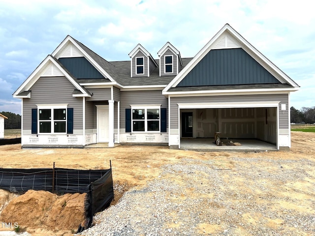 view of front of house with crawl space, a garage, board and batten siding, and driveway