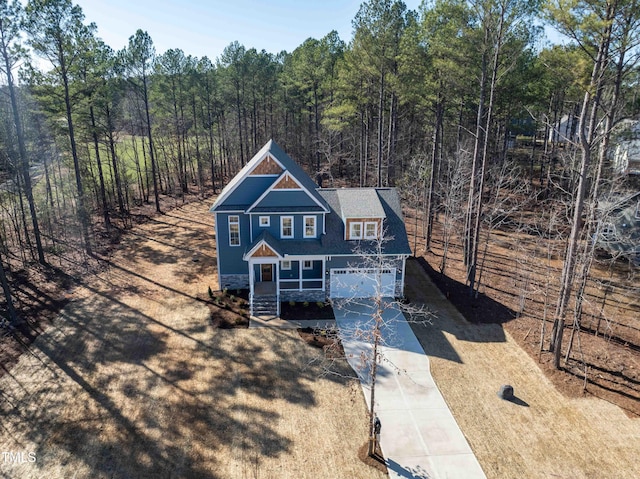 drone / aerial view with a wooded view