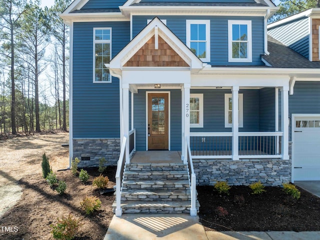 view of front of home with a garage, covered porch, stone siding, and a shingled roof