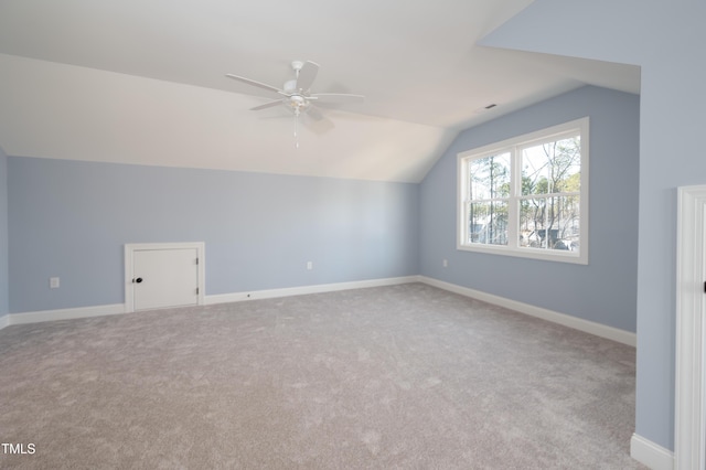 bonus room with vaulted ceiling, carpet, baseboards, and ceiling fan