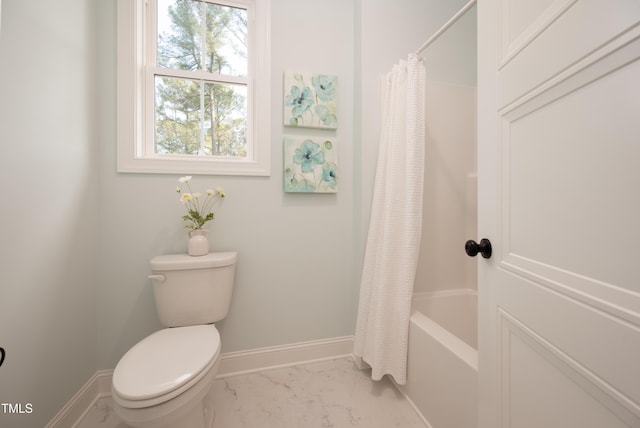 full bathroom featuring toilet, baseboards, marble finish floor, and shower / tub combo with curtain