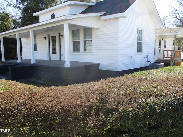 view of front of house featuring a porch and central air condition unit