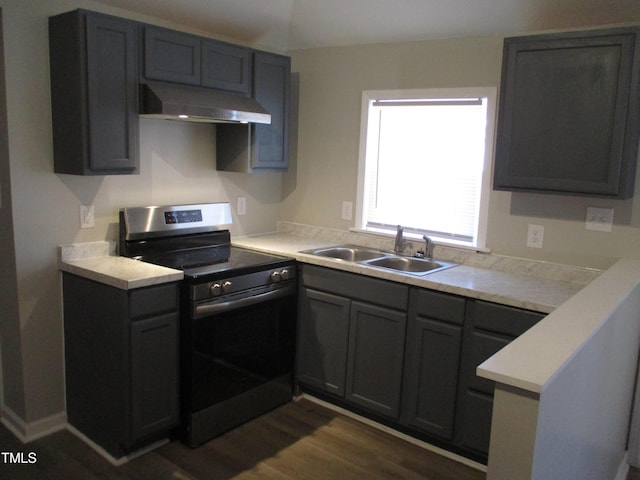 kitchen with gray cabinets, stove, dark wood-type flooring, and sink