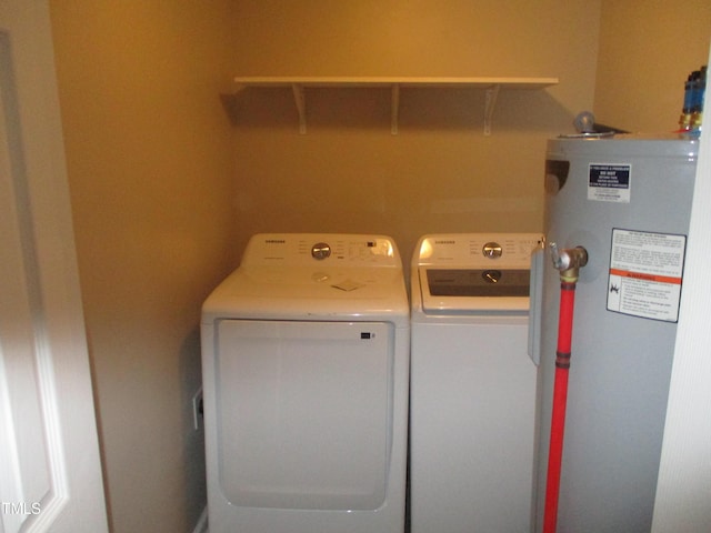 washroom with washing machine and dryer and gas water heater