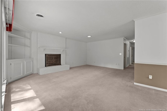 unfurnished living room with light carpet, a fireplace, crown molding, and built in features