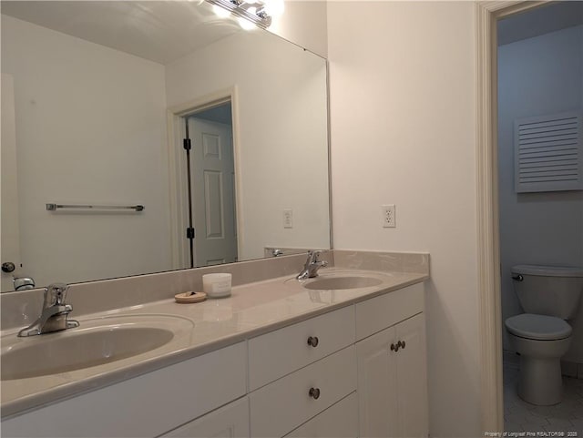 bathroom with tile patterned floors, vanity, and toilet