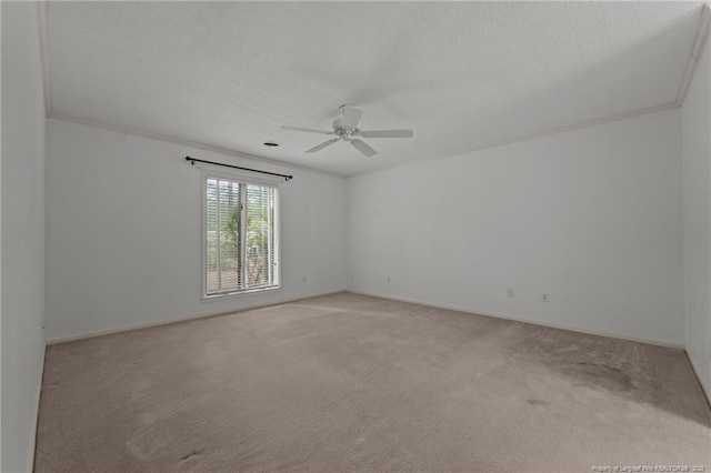 unfurnished room with light carpet, crown molding, ceiling fan, and a textured ceiling