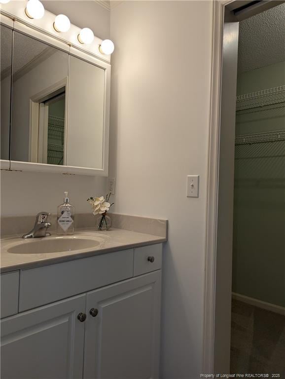 bathroom featuring vanity and a textured ceiling