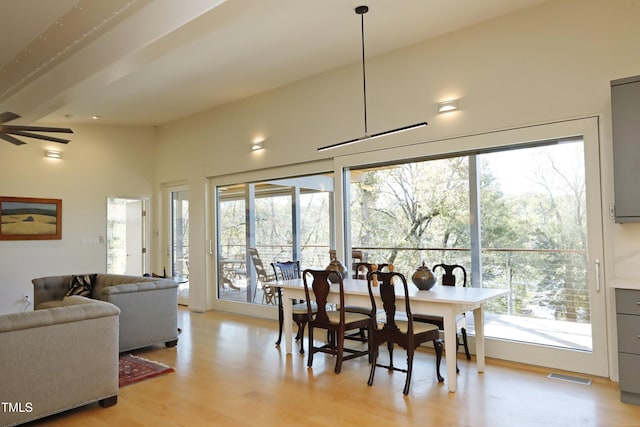 dining space with a wealth of natural light, light wood-style flooring, visible vents, and ceiling fan