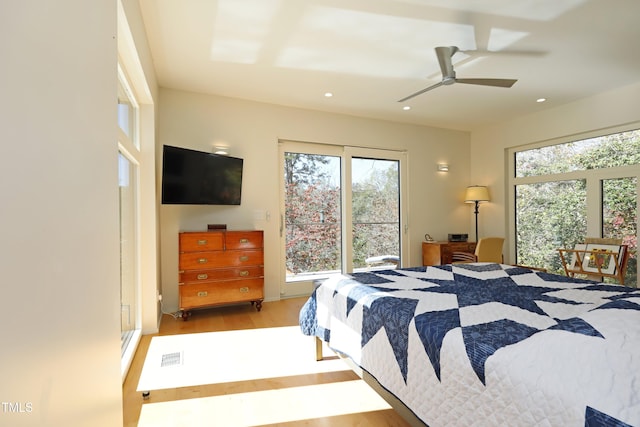 bedroom featuring recessed lighting, multiple windows, ceiling fan, and wood finished floors