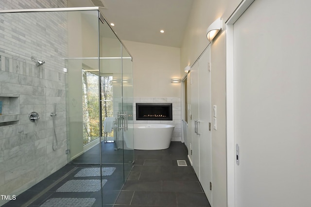 bathroom featuring a soaking tub, recessed lighting, a stall shower, tile patterned flooring, and tile walls