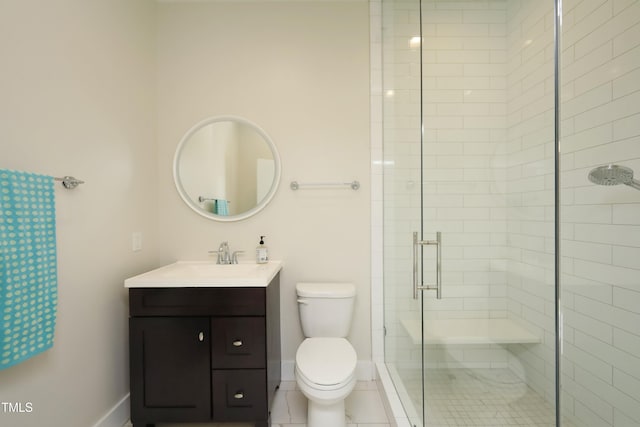 bathroom featuring vanity, toilet, baseboards, and a stall shower