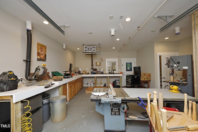 interior space featuring recessed lighting, finished concrete floors, and a workshop area