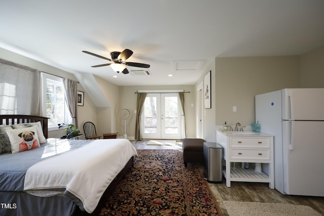 bedroom featuring access to exterior, multiple windows, visible vents, and freestanding refrigerator