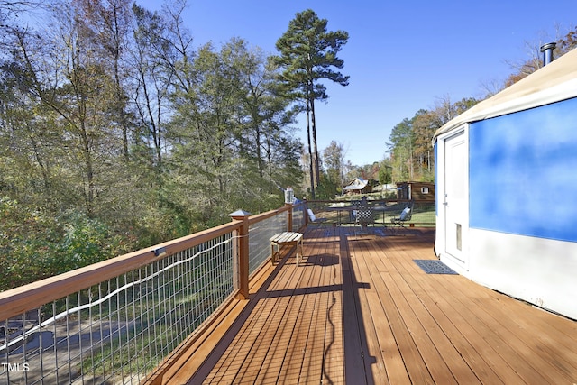 wooden deck featuring outdoor dining area