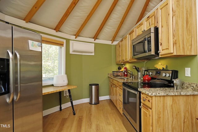 kitchen with light stone counters, baseboards, lofted ceiling with beams, light wood-style flooring, and appliances with stainless steel finishes