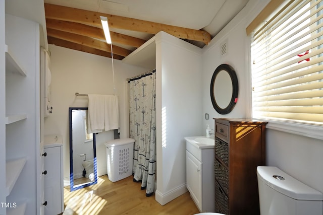 bathroom with vanity, wood finished floors, visible vents, washer / clothes dryer, and beamed ceiling