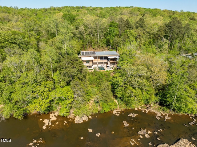 drone / aerial view with a view of trees and a water view