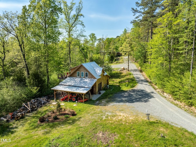 exterior space featuring a wooded view