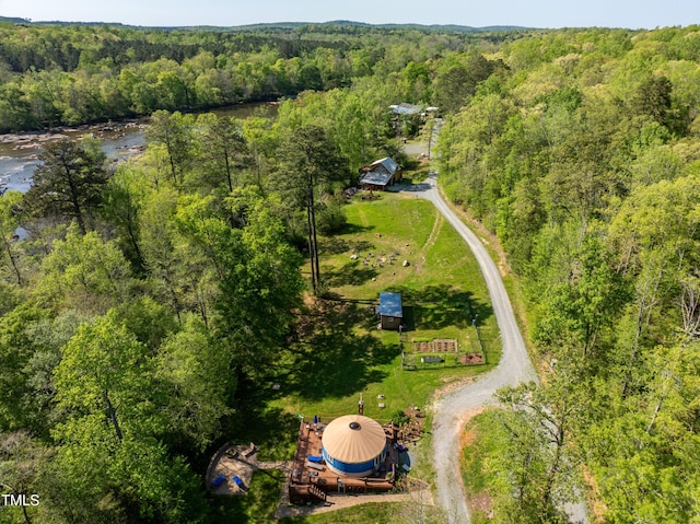 drone / aerial view featuring a wooded view