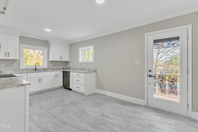 kitchen featuring white cabinetry, a healthy amount of sunlight, ornamental molding, and sink