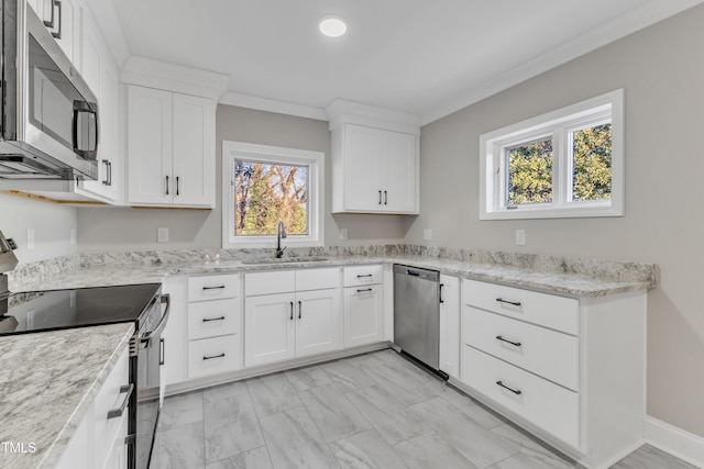 kitchen with appliances with stainless steel finishes, white cabinetry, sink, light stone counters, and crown molding