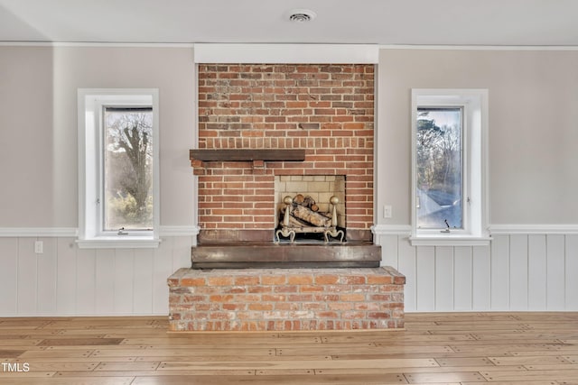 room details featuring a brick fireplace and hardwood / wood-style flooring