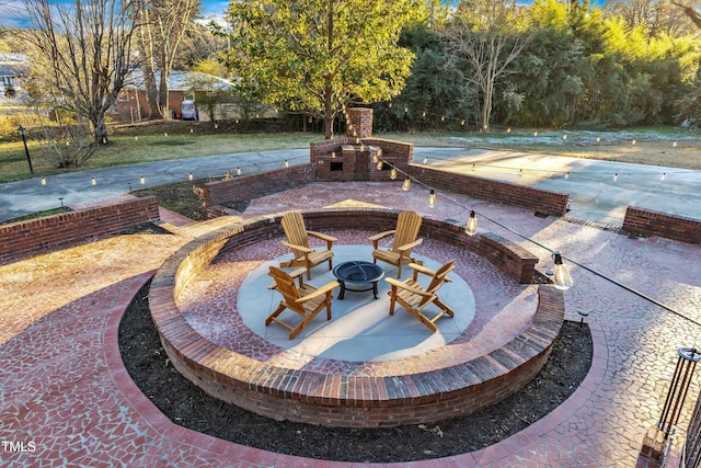 view of patio / terrace with exterior fireplace and a fire pit