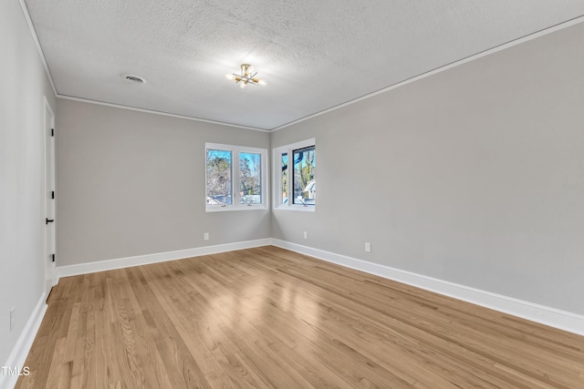 unfurnished room featuring a textured ceiling, crown molding, and light hardwood / wood-style flooring