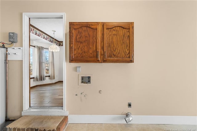 clothes washing area with hookup for an electric dryer, cabinets, and washer hookup