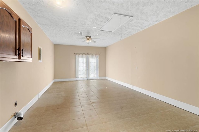 spare room featuring ceiling fan and a textured ceiling