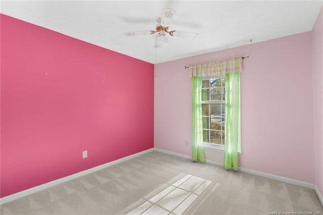 unfurnished room featuring light carpet and ceiling fan