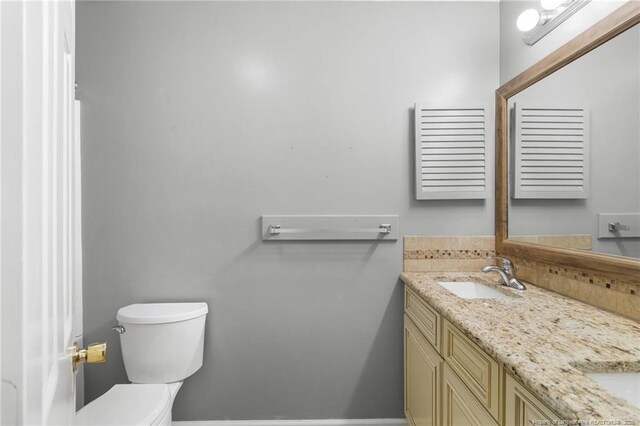 bathroom featuring vanity and toilet