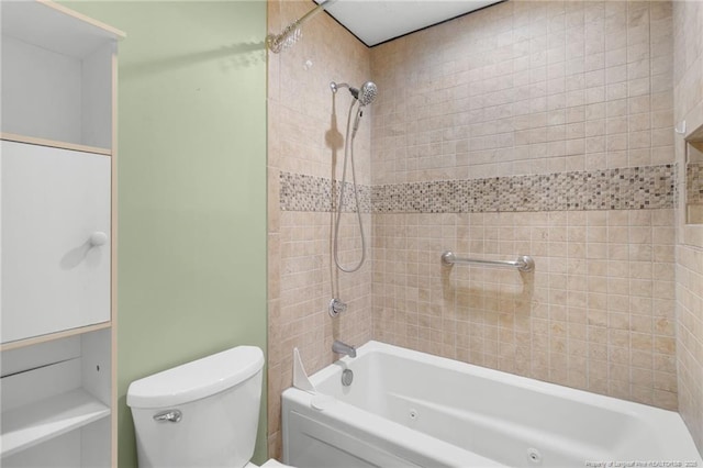 bathroom featuring toilet and tiled shower / bath