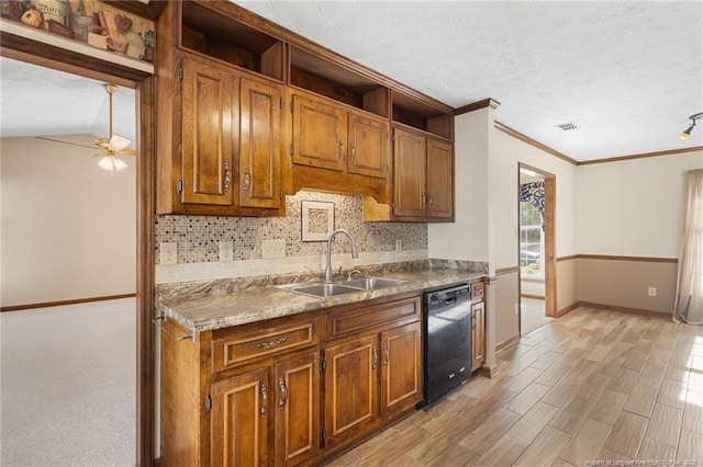 kitchen featuring ceiling fan, sink, black dishwasher, tasteful backsplash, and vaulted ceiling