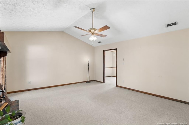 unfurnished room with ceiling fan, lofted ceiling, and light carpet