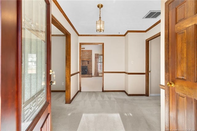 hall with light colored carpet and ornamental molding