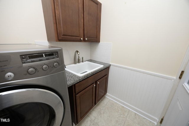 washroom featuring sink, cabinets, and washer / dryer