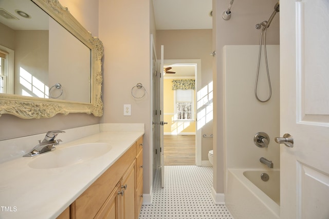 full bathroom with shower / tub combination, vanity, a healthy amount of sunlight, and toilet