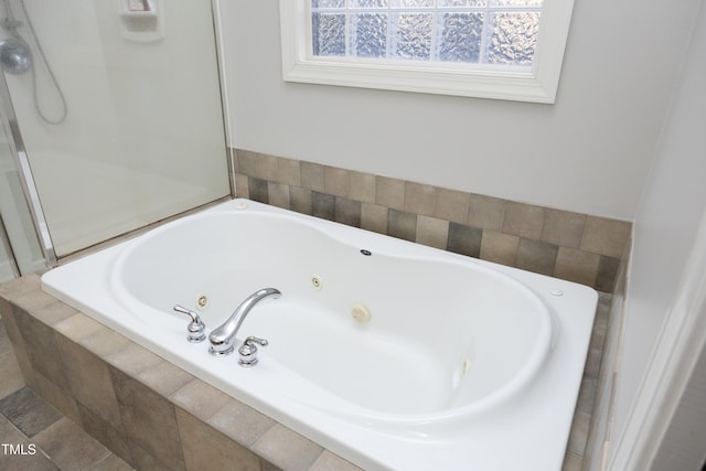 bathroom with a relaxing tiled tub