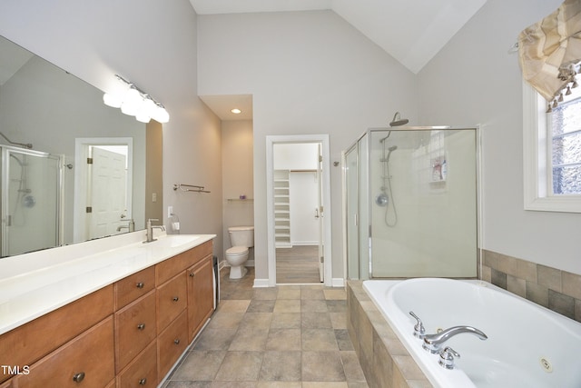 full bathroom featuring vanity, separate shower and tub, toilet, and vaulted ceiling