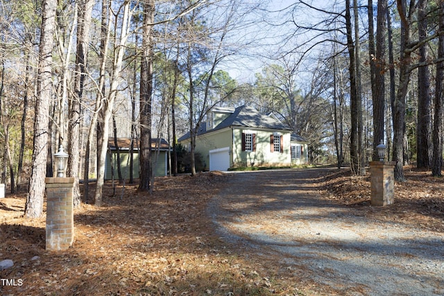 view of front facade featuring a garage and a water view