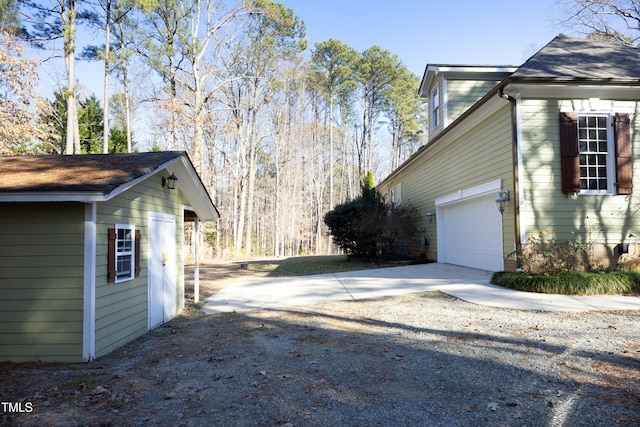 view of side of home featuring a garage