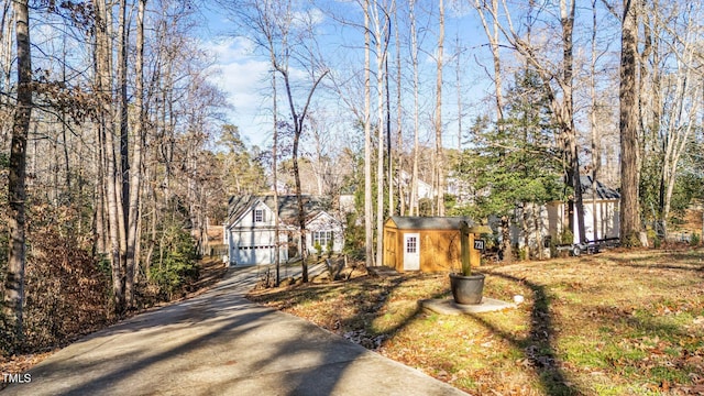 exterior space with a shed and a garage