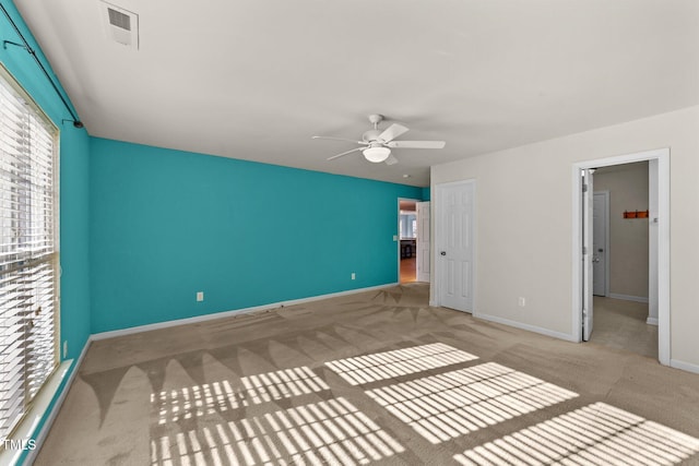 unfurnished bedroom with ceiling fan, light colored carpet, and a closet