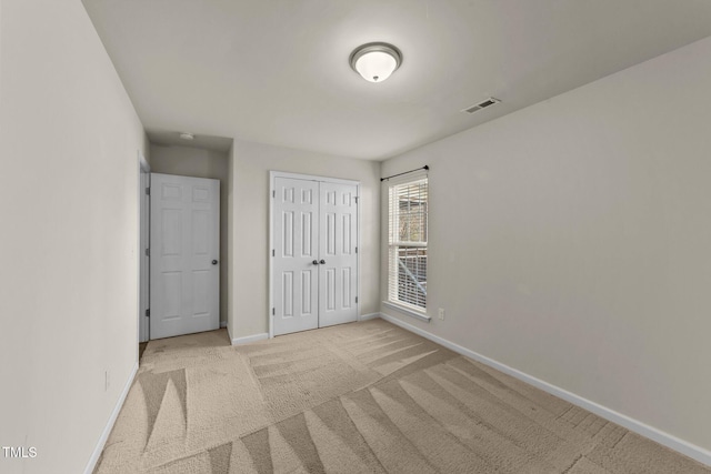 unfurnished bedroom with light carpet