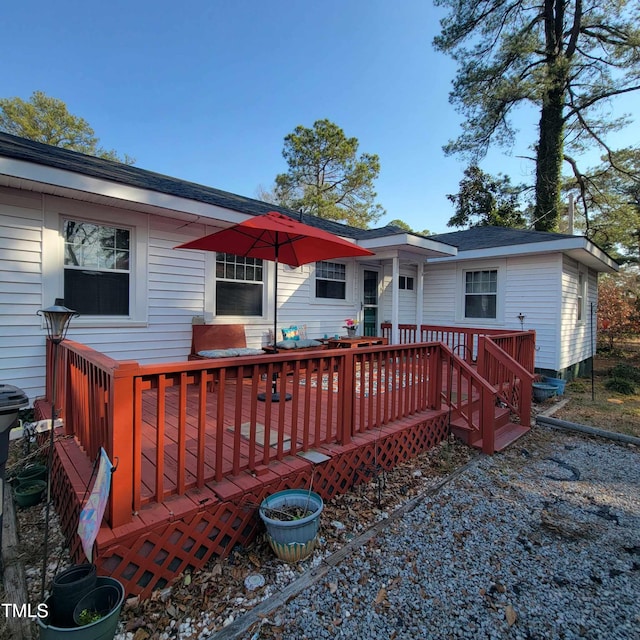 back of property featuring a wooden deck