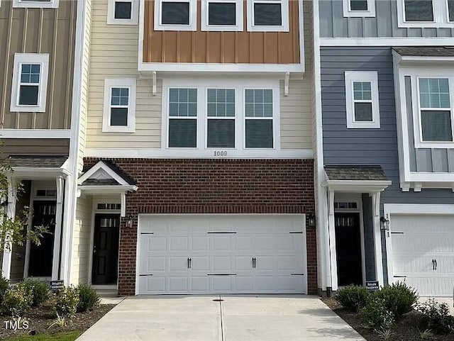 1009 Manorhaven Dr, Durham, NC 27703 - multi unit property featuring brick siding, board and batten siding, an attached garage, and driveway