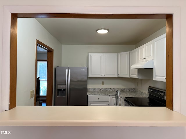 kitchen with white cabinets, stainless steel refrigerator with ice dispenser, black range with electric cooktop, and sink