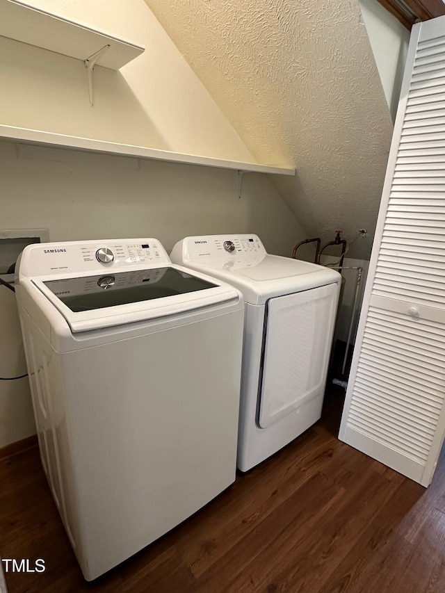 clothes washing area featuring washer and dryer and dark hardwood / wood-style flooring